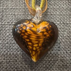 Art glass heart pendant on 16” ribbon.